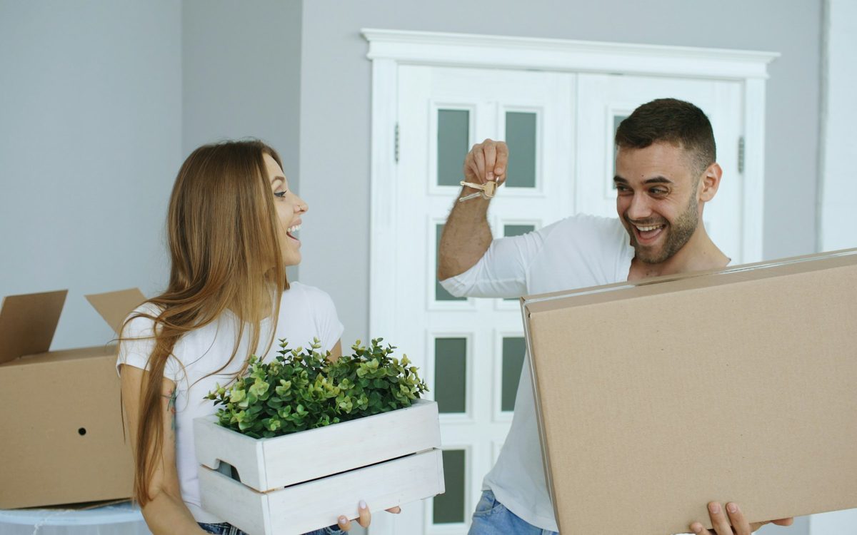 First-time homebuyers being handed the keys to their new home